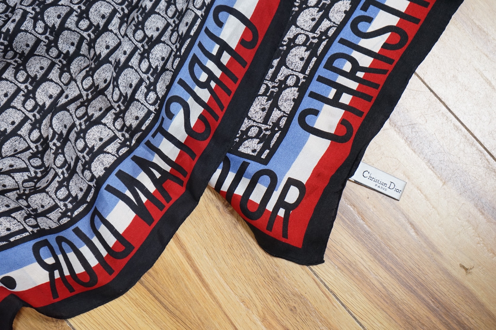 Three silk scarves comprising a Burberry check example, Christian Dior monogrammed and a Vakko abstract patterned example